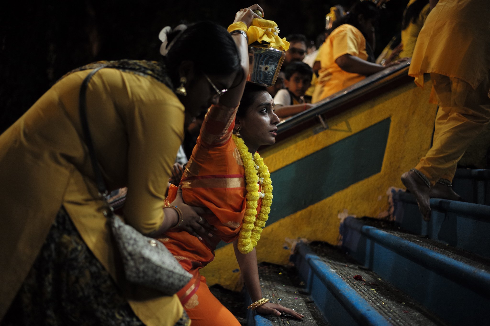 Pilgrims resting on the temple stairs at dawn