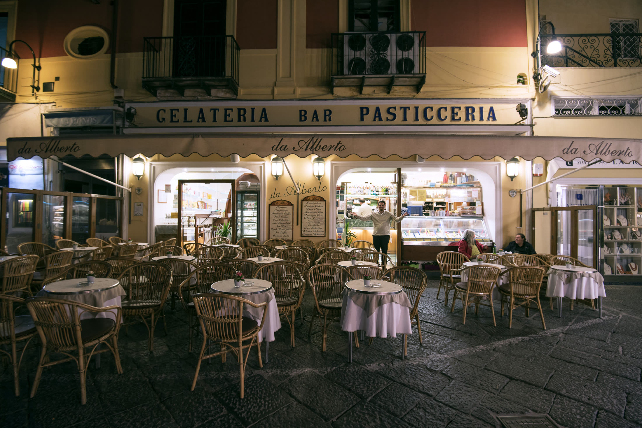 Empty tables outside a gelateria at night, Capri